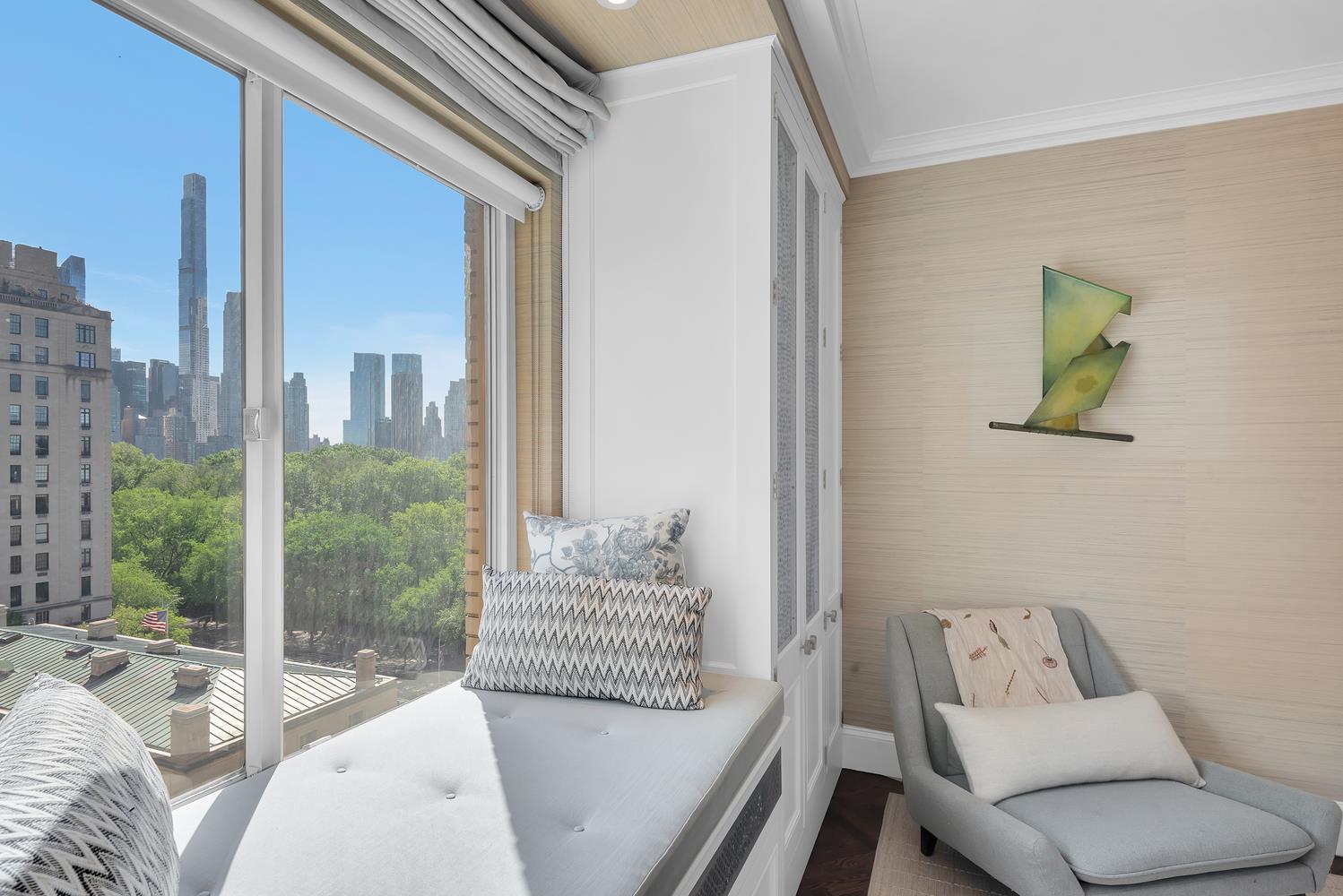 3 East 71st Street, Unit 10/11B Manhattan, NY 10021 - Photo 10 of 17 a living room with furniture and a floor to ceiling window