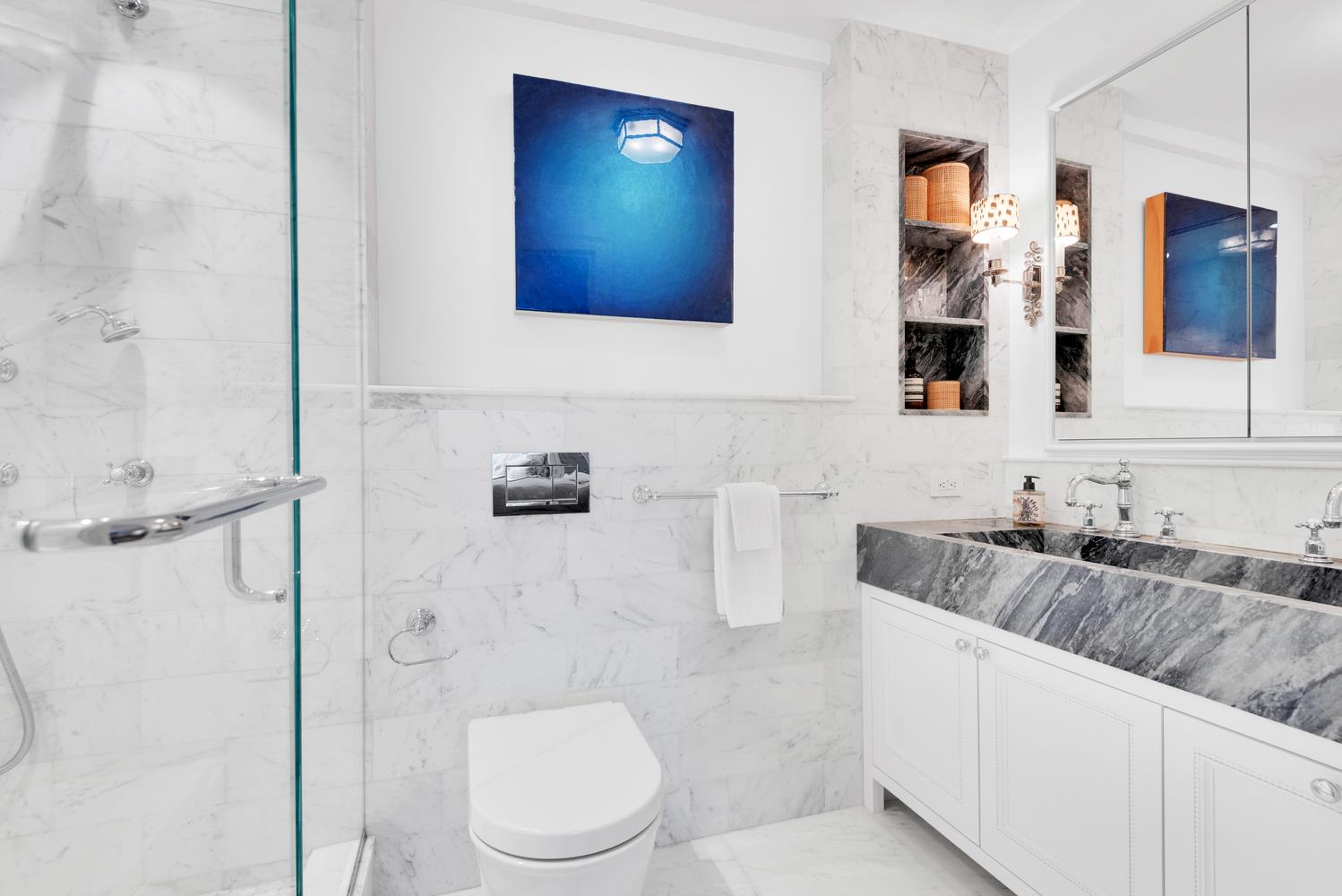 3 East 71st Street, Unit 10/11B Manhattan, NY 10021 - Photo 11 of 17 a bathroom with a granite countertop sink mirror vanity and toilet