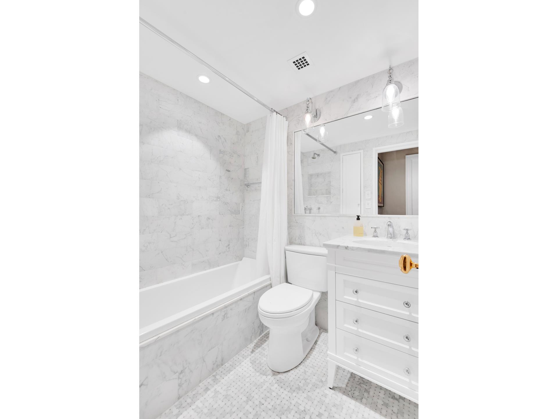 3 East 71st Street, Unit 10/11B Manhattan, NY 10021 - Photo 14 of 17 a bathroom with a sink a toilet and shower