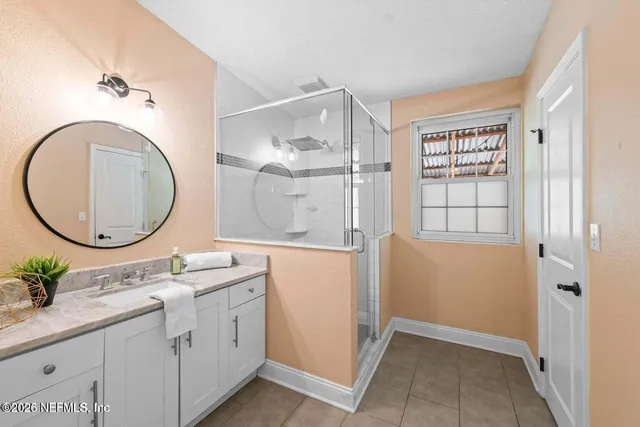 a bathroom with a granite countertop sink mirror and vanity