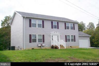 3065 Cox Road Chesapeake Beach, MD 20732 - Photo 1 of 17 a front view of a house with a garden