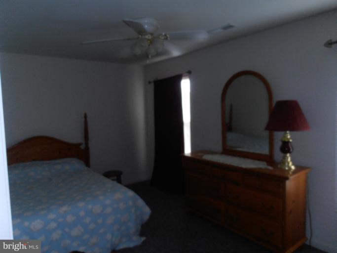 3065 Cox Road Chesapeake Beach, MD 20732 - Photo 12 of 17 a bedroom with a bed next to a window