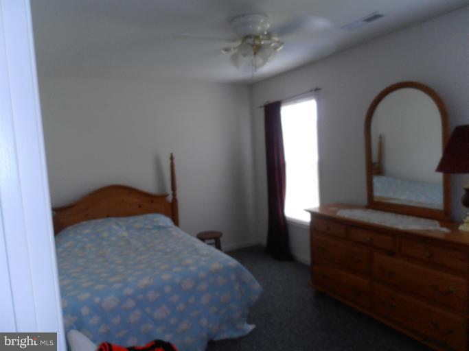 3065 Cox Road Chesapeake Beach, MD 20732 - Photo 13 of 17 a bedroom with a bed and a window
