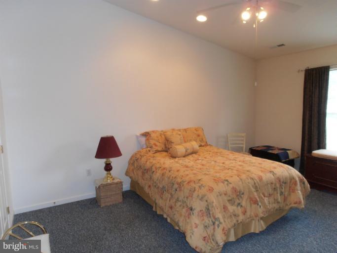 3065 Cox Road Chesapeake Beach, MD 20732 - Photo 16 of 17 a bed sitting in a bedroom next to a window with tv