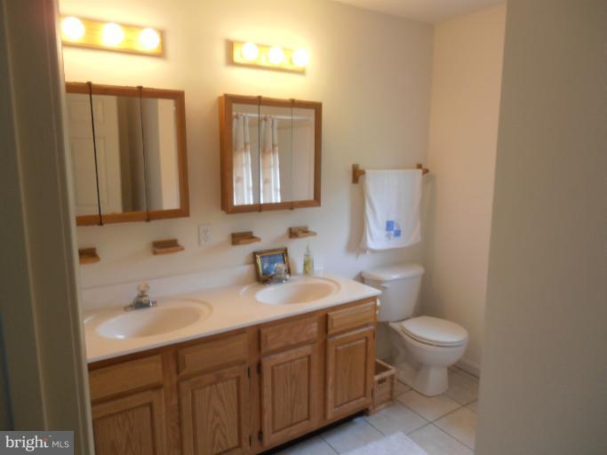 3065 Cox Road Chesapeake Beach, MD 20732 - Photo 17 of 17 a bathroom with a toilet sink and mirror