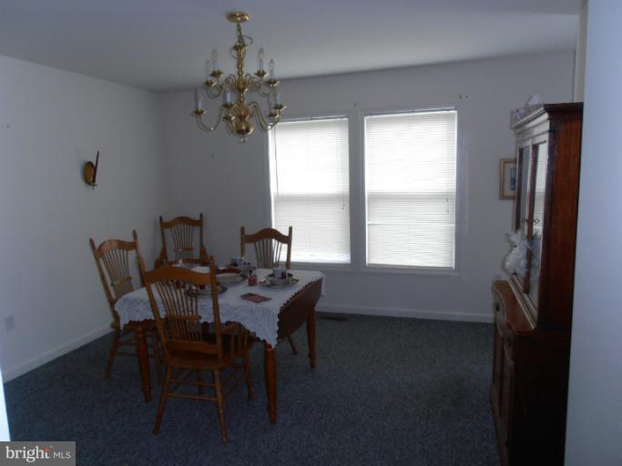 3065 Cox Road Chesapeake Beach, MD 20732 - Photo 7 of 17 a view of a dining room with furniture and window