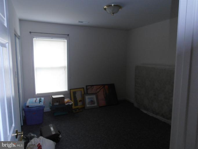 3065 Cox Road Chesapeake Beach, MD 20732 - Photo 10 of 17 a bed sitting in a bedroom next to a window