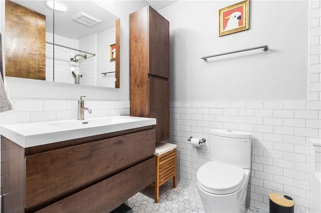 a bathroom with a sink toilet and shower