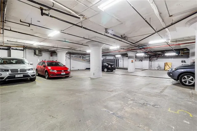 a view of parking garage with cars