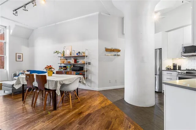 a view of a dining room with furniture and wooden floor