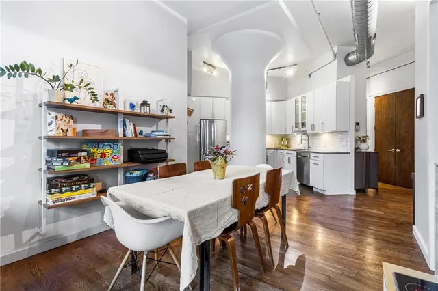 a view of a dining room with furniture and wooden floor