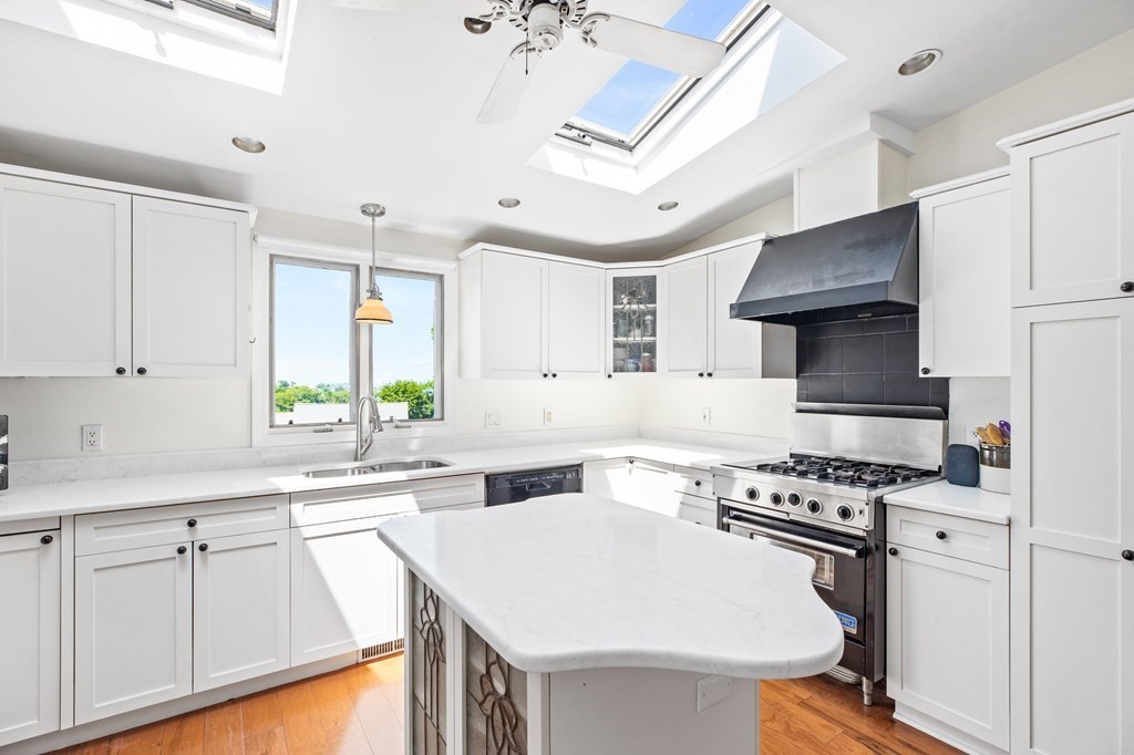 29 Governor Long Road Hingham, MA 02043 - Photo 11 of 39 a kitchen with stainless steel appliances a sink a stove a refrigerator cabinets and a window