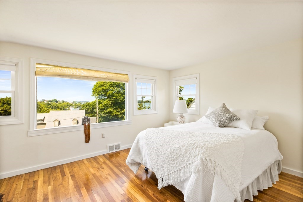 29 Governor Long Road Hingham, MA 02043 - Photo 14 of 39 a bedroom with a large bed and a large window