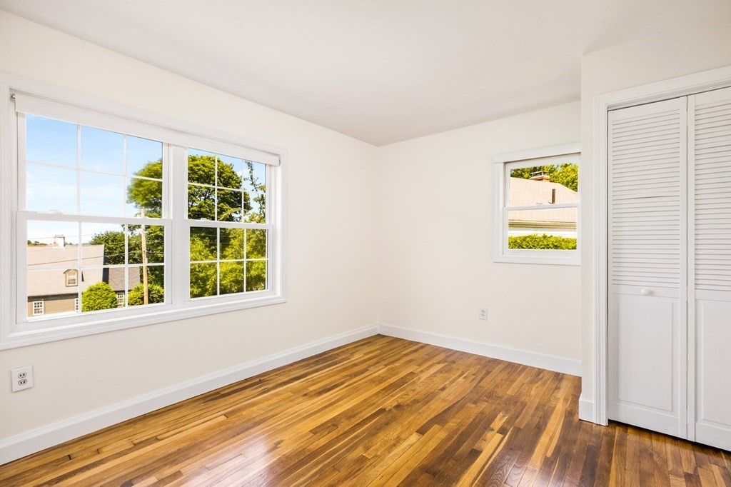 29 Governor Long Road Hingham, MA 02043 - Photo 21 of 39 a view of an empty room with a window and a kitchen