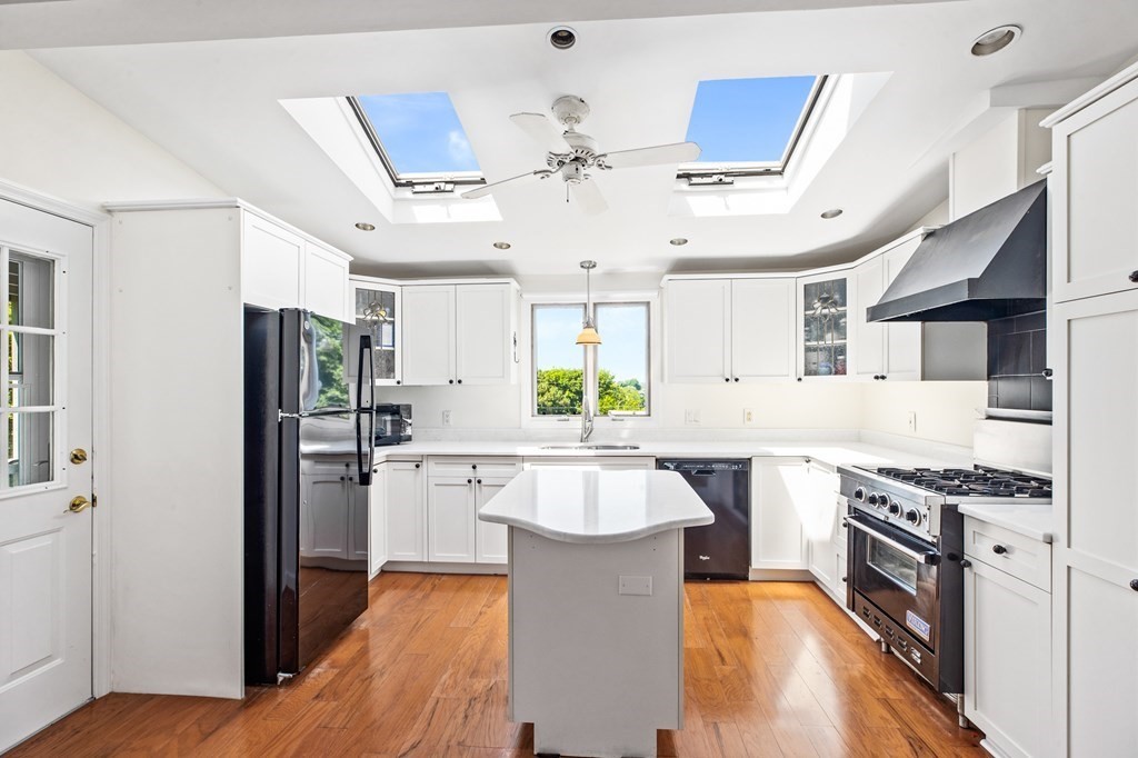 29 Governor Long Road Hingham, MA 02043 - Photo 10 of 39 a large kitchen with stainless steel appliances kitchen island granite countertop a lot of counter space and wooden floor