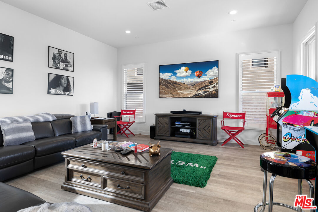 20234 Jubilee Way Porter Ranch, CA 91326 - Photo 10 of 30 a living room with furniture a fireplace and a flat screen tv