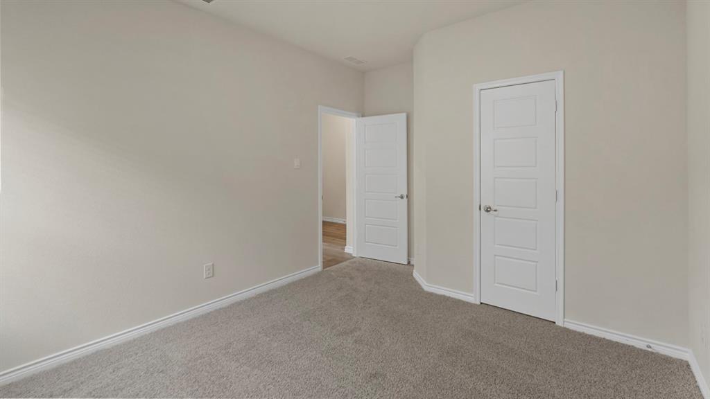 447 Epiphany Lane Lavon, TX 75166 - Photo 24 of 31 Neutral-toned walls and grey carpeting define this interior space