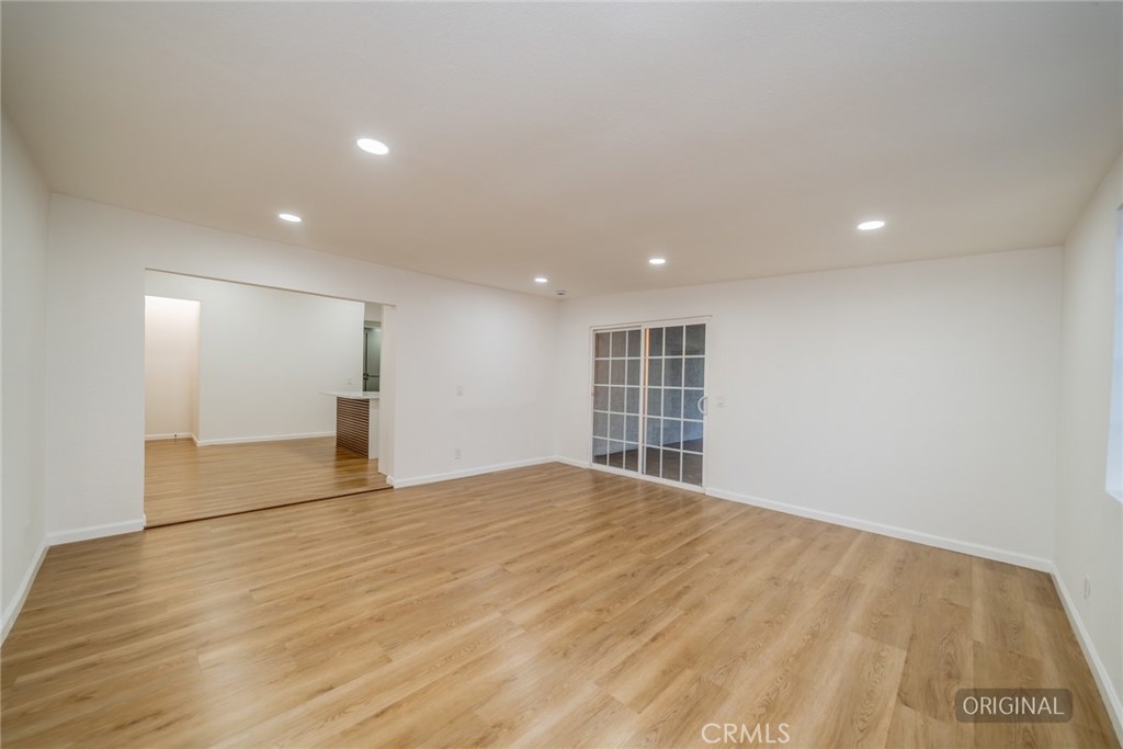 555 North Chestnut Avenue Rialto, CA 92376 - Photo 10 of 33 a view of empty room with wooden floor and windows