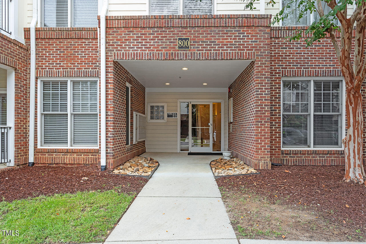 800 Moratuck Drive, Unit 102 Raleigh, NC 27604 - Photo 1 of 36 a front view of a house with a yard and garage