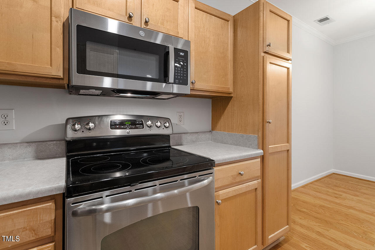 800 Moratuck Drive, Unit 102 Raleigh, NC 27604 - Photo 14 of 36 a stove top oven sitting inside of a kitchen