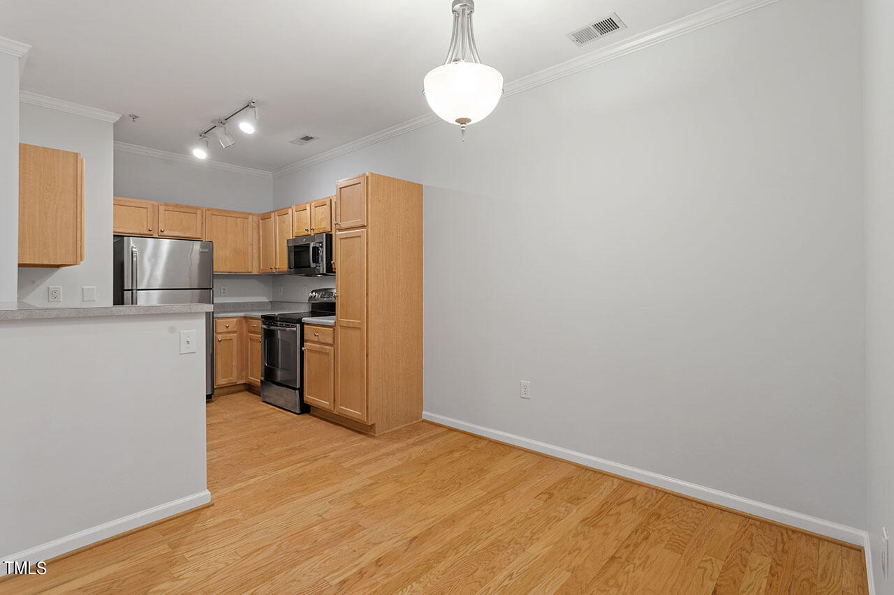 800 Moratuck Drive, Unit 102 Raleigh, NC 27604 - Photo 17 of 36 a kitchen with stainless steel appliances a refrigerator and a stove top oven