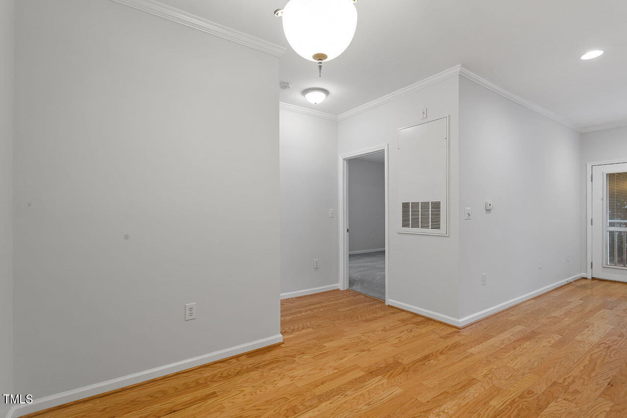 800 Moratuck Drive, Unit 102 Raleigh, NC 27604 - Photo 19 of 36 a view of empty room with wooden floor
