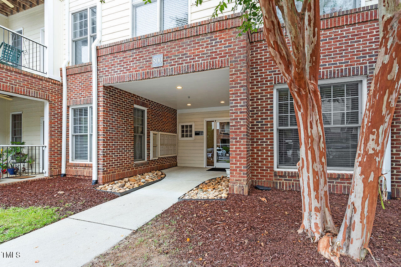 800 Moratuck Drive, Unit 102 Raleigh, NC 27604 - Photo 2 of 36 a front view of a house with a porch