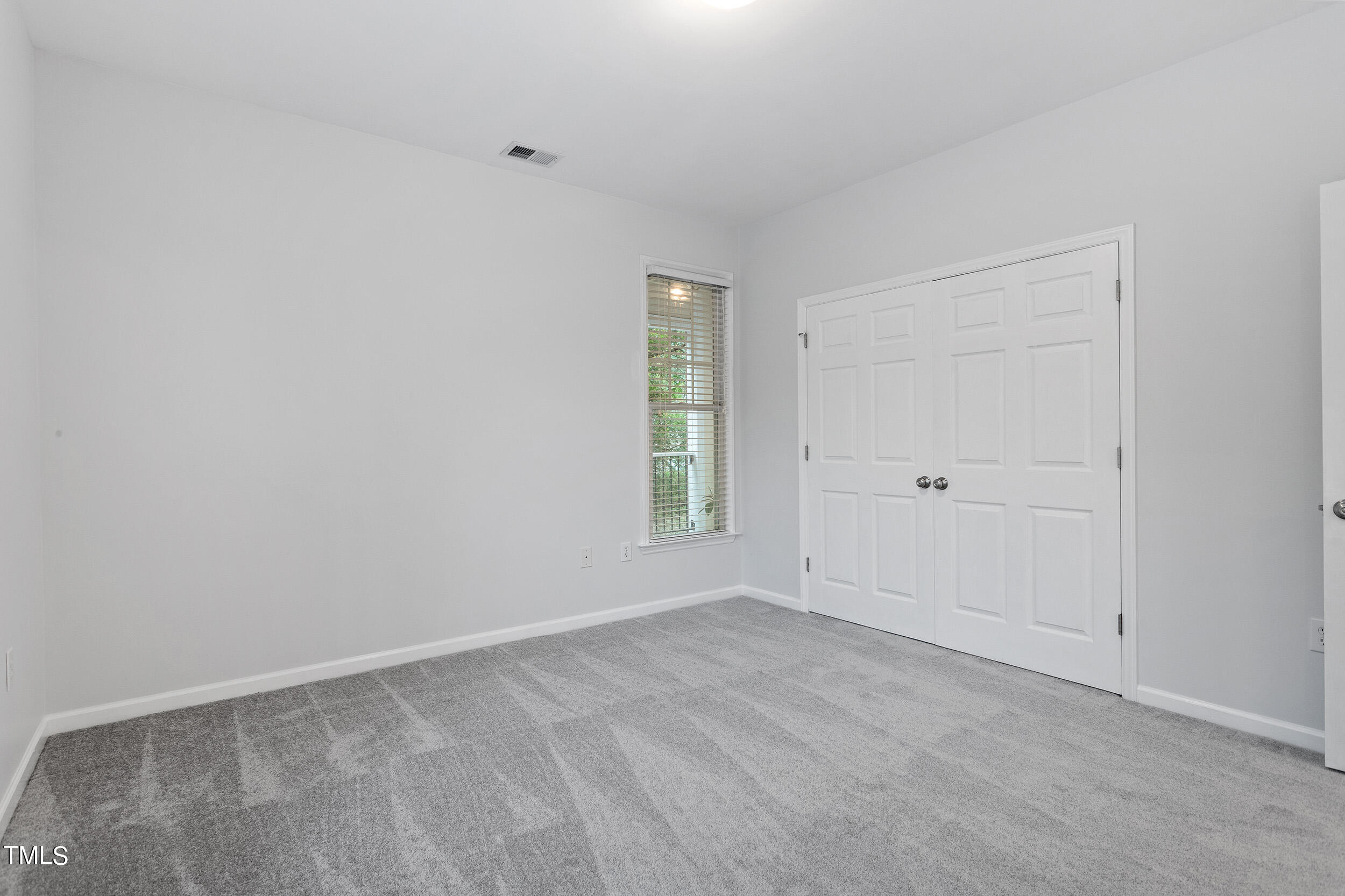 800 Moratuck Drive, Unit 102 Raleigh, NC 27604 - Photo 23 of 36 a view of an empty room with a window