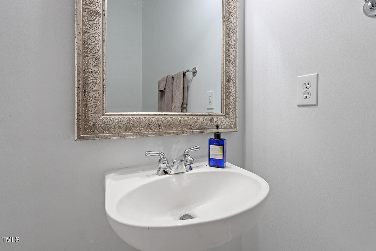 800 Moratuck Drive, Unit 102 Raleigh, NC 27604 - Photo 30 of 36 a bathroom with a sink and a mirror