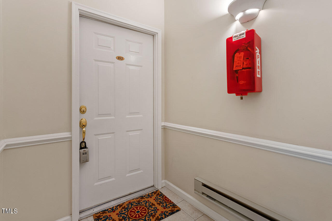 800 Moratuck Drive, Unit 102 Raleigh, NC 27604 - Photo 4 of 36 a room with a door and a rug