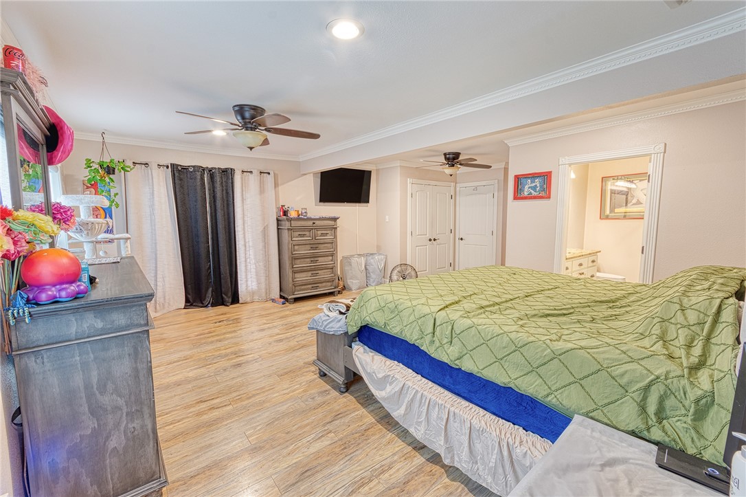 1202 Crosby Street Portland, TX 78374 - Photo 13 of 20 a spacious bedroom with a bed dresser and a window
