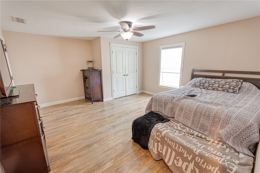 1202 Crosby Street Portland, TX 78374 - Photo 16 of 20 a bedroom with a bed and window