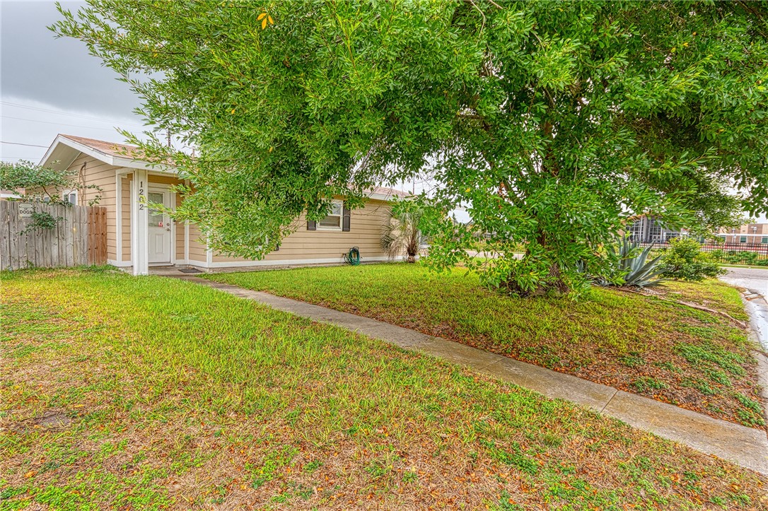 1202 Crosby Street Portland, TX 78374 - Photo 2 of 20 a view of a big yard with large trees and plants