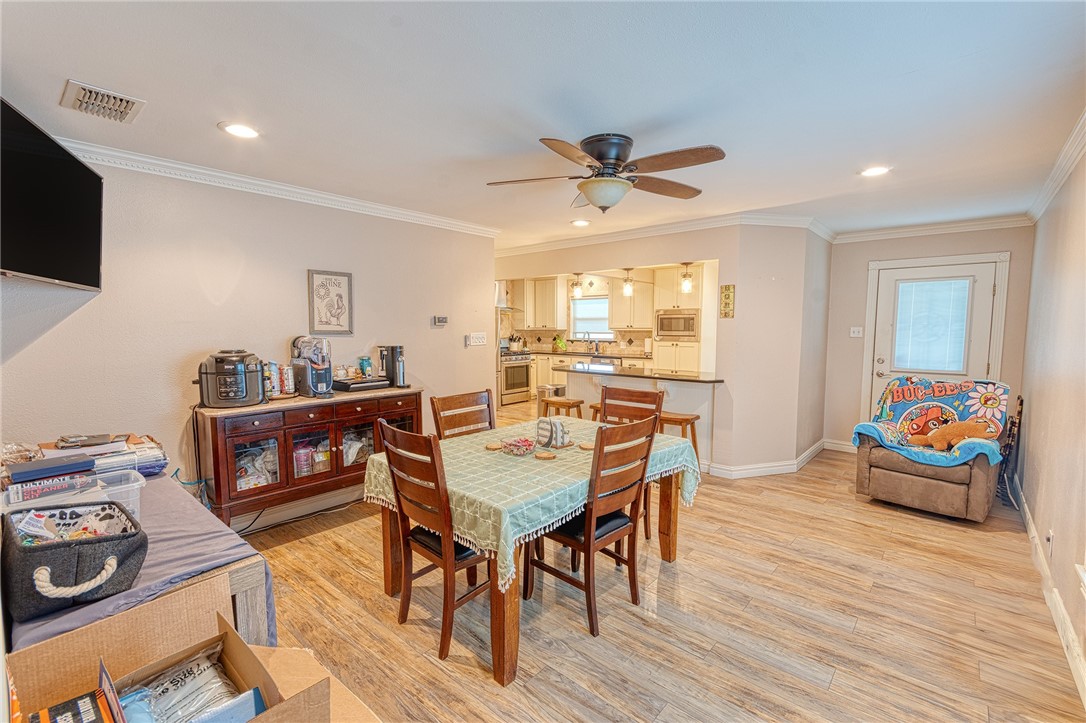 1202 Crosby Street Portland, TX 78374 - Photo 5 of 20 a view of a dining room with furniture and wooden floor