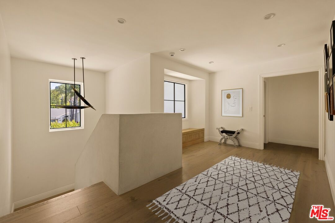 9872 Whitwell Drive Beverly Hills, CA 90210 - Photo 17 of 32 a bedroom with a bed and wooden floor