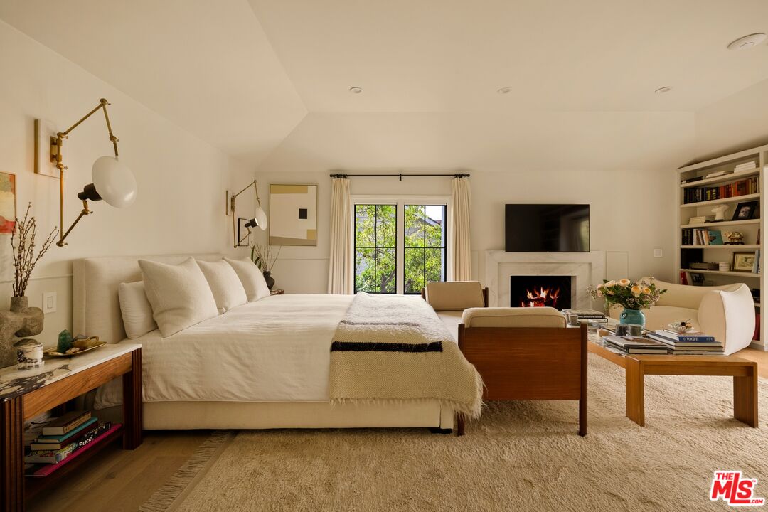 9872 Whitwell Drive Beverly Hills, CA 90210 - Photo 18 of 32 a bedroom with a bed and a flat screen tv