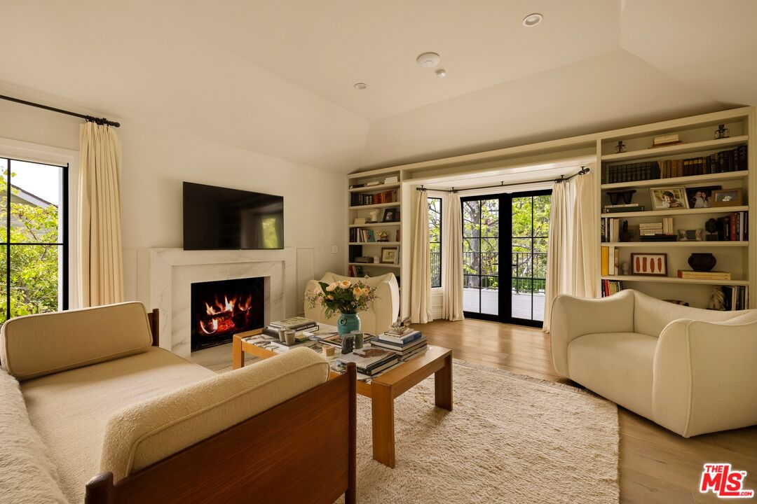 9872 Whitwell Drive Beverly Hills, CA 90210 - Photo 19 of 32 a living room with furniture and a fireplace