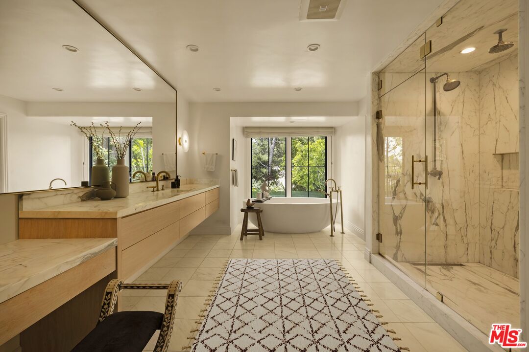 9872 Whitwell Drive Beverly Hills, CA 90210 - Photo 21 of 32 a large bathroom with a glass door shower and sink