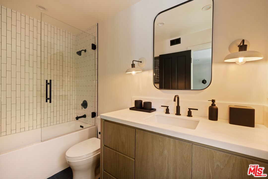 9872 Whitwell Drive Beverly Hills, CA 90210 - Photo 24 of 32 a bathroom with a sink toilet tub and shower