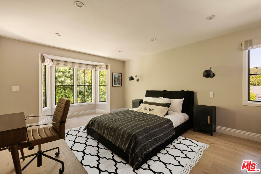 9872 Whitwell Drive Beverly Hills, CA 90210 - Photo 25 of 32 a bedroom with a bed and a window