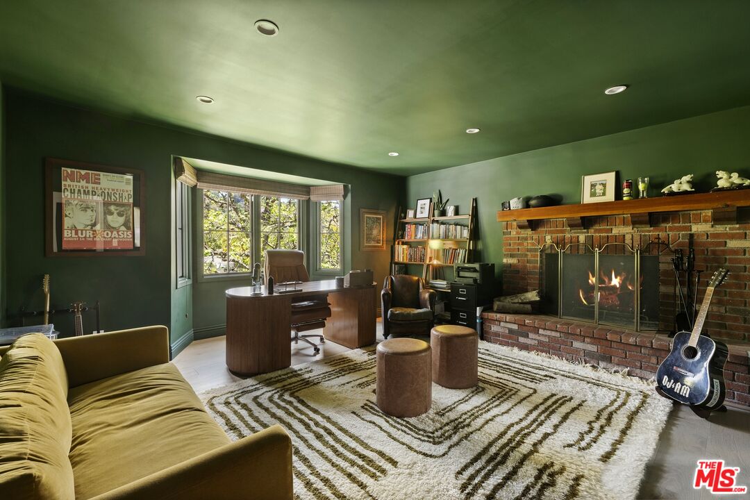 9872 Whitwell Drive Beverly Hills, CA 90210 - Photo 26 of 32 a living room with furniture a rug and a floor to ceiling window