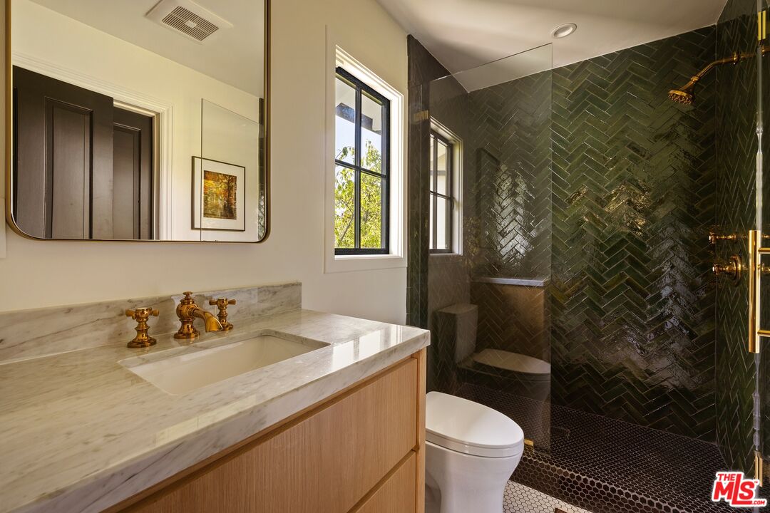 9872 Whitwell Drive Beverly Hills, CA 90210 - Photo 27 of 32 a bathroom with a sink toilet and a mirror