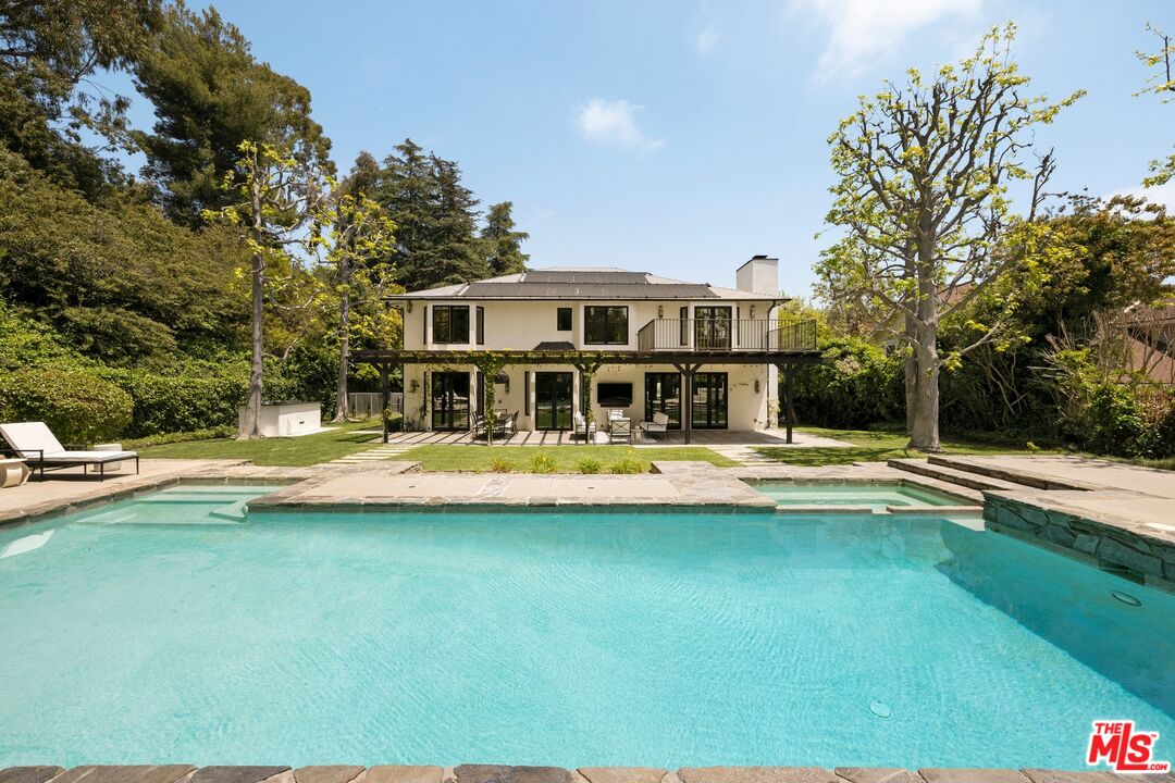 9872 Whitwell Drive Beverly Hills, CA 90210 - Photo 29 of 32 a front view of a house with a yard