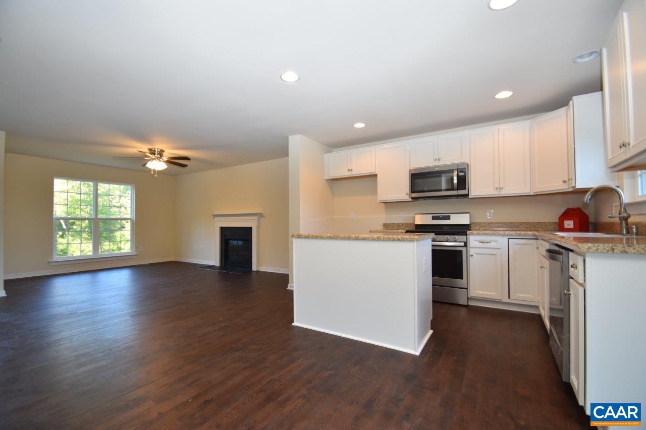 87 Riva Way Palmyra, VA 22963 - Photo 2 of 19 a kitchen with granite countertop a stove a sink dishwasher and a refrigerator with wooden floor