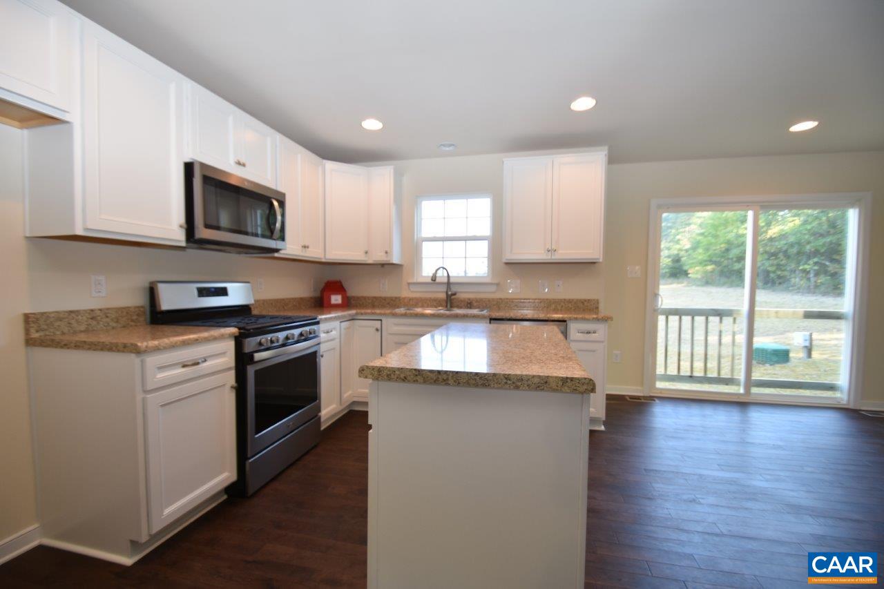 87 Riva Way Palmyra, VA 22963 - Photo 4 of 19 a kitchen with stainless steel appliances granite countertop a stove a sink and a microwave