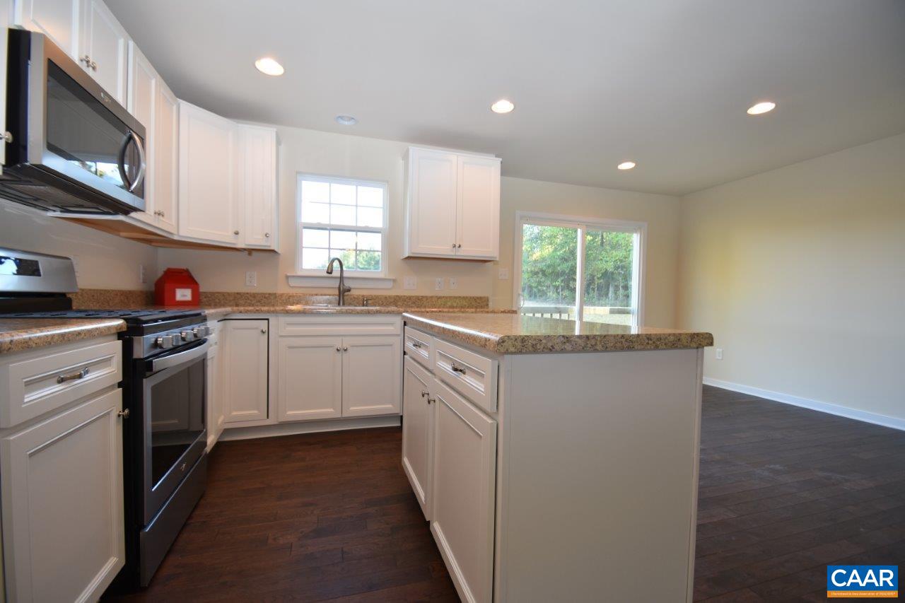 87 Riva Way Palmyra, VA 22963 - Photo 5 of 19 a kitchen with granite countertop white cabinets stainless steel appliances a sink and a window