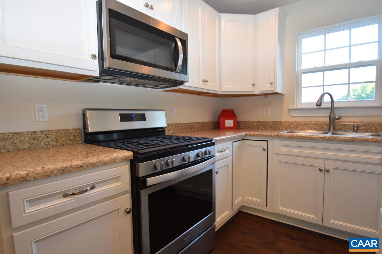 87 Riva Way Palmyra, VA 22963 - Photo 6 of 19 a kitchen with granite countertop a stove microwave and sink