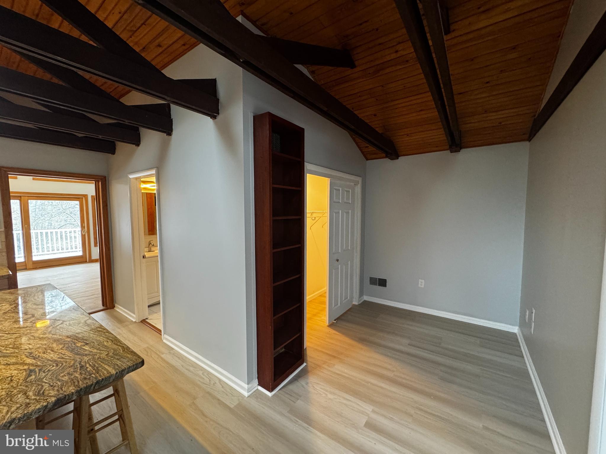 2427 Grubb Road Wilmington, DE 19810 - Photo 21 of 32 a view of an empty room with wooden floor and a window