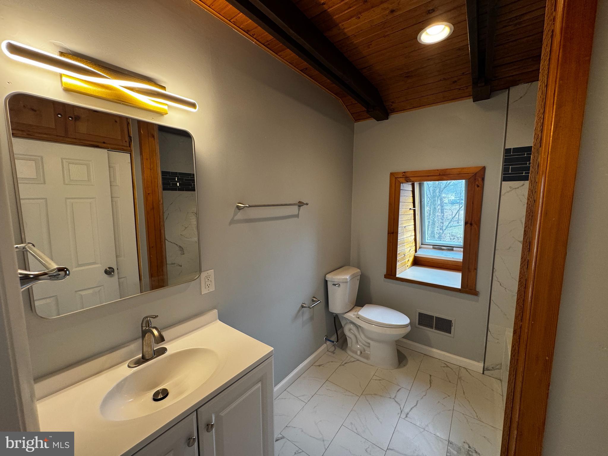 2427 Grubb Road Wilmington, DE 19810 - Photo 25 of 32 a bathroom with a sink toilet and mirror