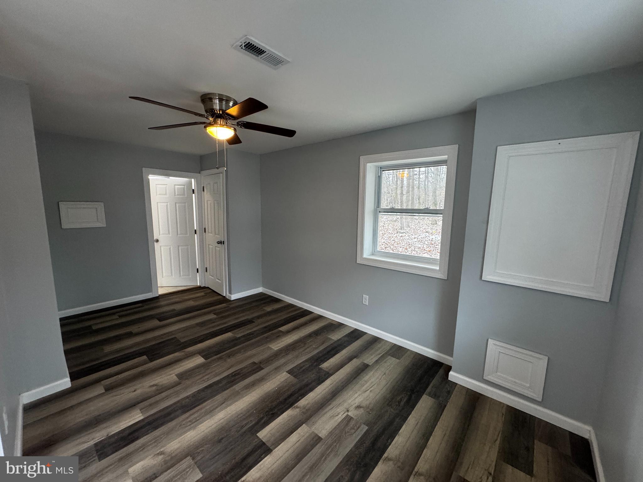 2427 Grubb Road Wilmington, DE 19810 - Photo 3 of 32 a bedroom with wooden floor ceiling fan and a window